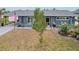 Gray house with landscaped yard, driveway, and American flag at 4310 Albacore Cir, Port Charlotte, FL 33948