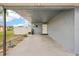 Gray house with carport, landscaped yard, and American flag at 4310 Albacore Cir, Port Charlotte, FL 33948