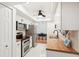 Modern kitchen with stainless steel appliances and butcher block countertops at 4310 Albacore Cir, Port Charlotte, FL 33948