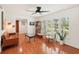 Living room with hardwood floors, a leather couch, and a ceiling fan at 4310 Albacore Cir, Port Charlotte, FL 33948