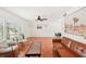 Bright living room with hardwood floors, a leather couch, and large windows at 4310 Albacore Cir, Port Charlotte, FL 33948