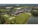 Aerial view of community clubhouse, pool, golf course, and tennis courts at 438 Grand Preserve Cv, Bradenton, FL 34212