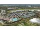 Aerial view of community tennis courts, pool, and parking areas at 438 Grand Preserve Cv, Bradenton, FL 34212