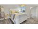 Guest bedroom with a full-size bed and yellow accents at 438 Grand Preserve Cv, Bradenton, FL 34212