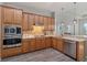 Modern kitchen featuring stainless steel appliances and wood cabinets at 438 Grand Preserve Cv, Bradenton, FL 34212