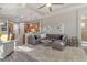 Open living room and kitchen with large sectional sofa and hardwood floors at 438 Grand Preserve Cv, Bradenton, FL 34212
