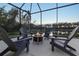 Relaxing screened patio with fire pit and lake view at 438 Grand Preserve Cv, Bradenton, FL 34212
