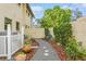 Landscaped backyard with walkway and gate at 440 Palmetto Ct # 3, Venice, FL 34285