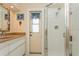 Bathroom with shower, vanity, and door to backyard at 440 Palmetto Ct # 3, Venice, FL 34285