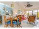Charming dining area with wood table and blue chairs at 440 Palmetto Ct # 3, Venice, FL 34285