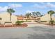 Condo complex with Spanish-style architecture and meticulously maintained landscaping at 440 Palmetto Ct # 3, Venice, FL 34285