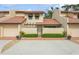 Two story condo with Spanish tile roof, attached garage, and landscaped front at 440 Palmetto Ct # 3, Venice, FL 34285