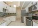 Modern kitchen with white cabinets and stainless steel appliances at 440 Palmetto Ct # 3, Venice, FL 34285