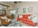 Cozy living room with coral sofa, wicker chairs, and access to a private patio at 440 Palmetto Ct # 3, Venice, FL 34285
