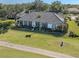 House with tile roof, screened porch, and landscaped yard at 441 Tremingham Way, Venice, FL 34293
