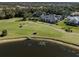 Aerial view of home on golf course with pool and lush landscaping at 441 Tremingham Way, Venice, FL 34293