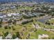 Community overview featuring golf course, pool, and tennis courts at 441 Tremingham Way, Venice, FL 34293