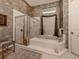 Spa-like bathroom featuring a large tub and shower at 441 Tremingham Way, Venice, FL 34293