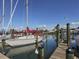 Boats docked at a wooden pier on calm water at 441 Tremingham Way, Venice, FL 34293