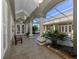 Peaceful courtyard with columns, lush plants, and a pool at 441 Tremingham Way, Venice, FL 34293