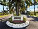 The Reserve community entrance with palm trees and landscaping at 441 Tremingham Way, Venice, FL 34293