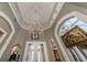 View of entry with detailed ceiling and chandelier at 441 Tremingham Way, Venice, FL 34293