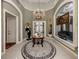 Elegant entry with high ceilings, chandelier, and stained glass window at 441 Tremingham Way, Venice, FL 34293