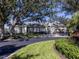 One-story house with a gray facade, shutters, and a driveway at 441 Tremingham Way, Venice, FL 34293