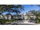 House with a gray facade, shutters, and a paved driveway at 441 Tremingham Way, Venice, FL 34293