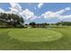 Golf course with pond and lush green fairways at 441 Tremingham Way, Venice, FL 34293