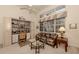 Bright home office with built-in shelving and comfortable seating at 441 Tremingham Way, Venice, FL 34293