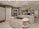 Island kitchen with breakfast bar, white cabinets, and stainless steel appliances at 441 Tremingham Way, Venice, FL 34293