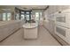 Spacious kitchen featuring island, ample cabinetry, and high-end appliances at 441 Tremingham Way, Venice, FL 34293