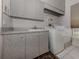 Functional laundry room with washer, dryer, and cabinets at 441 Tremingham Way, Venice, FL 34293