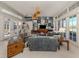 Living room with ample natural light, comfortable seating, and a wall of artwork at 441 Tremingham Way, Venice, FL 34293