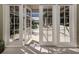 Inviting pool area with French doors leading outside at 441 Tremingham Way, Venice, FL 34293
