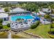 Community pool with deck and surrounding landscaping at 441 Tremingham Way, Venice, FL 34293