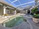 Resort-style pool and spa with covered patio at 441 Tremingham Way, Venice, FL 34293
