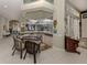 Wet bar with granite countertop and seating for two, adjacent to the living area at 441 Tremingham Way, Venice, FL 34293