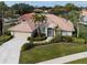 Single-Gathering home with tile roof, landscaping, and driveway at 5045 Whitestone Dr, Venice, FL 34293