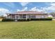Spacious backyard with screened patio and lush landscaping at 5045 Whitestone Dr, Venice, FL 34293