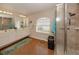 Bathroom boasts double vanity, large shower, and light wood floors at 5045 Whitestone Dr, Venice, FL 34293