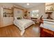 Bright bedroom with built-in shelves and wood flooring at 5045 Whitestone Dr, Venice, FL 34293