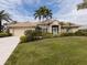 Single-story home with tile roof, screened porch and manicured lawn at 5045 Whitestone Dr, Venice, FL 34293