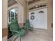Inviting front porch with green chairs and a wreath on the door at 5045 Whitestone Dr, Venice, FL 34293