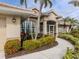 Well-maintained landscaping leads to a home with a screened porch at 5045 Whitestone Dr, Venice, FL 34293