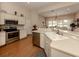 Open kitchen with stainless steel appliances and breakfast bar at 5045 Whitestone Dr, Venice, FL 34293