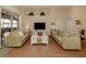 Bright living room featuring light green sofas and a white coffee table at 5045 Whitestone Dr, Venice, FL 34293