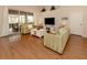 Spacious living room with two sofas, a coffee table, and hardwood floors at 5045 Whitestone Dr, Venice, FL 34293