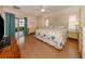 Main bedroom with king-size bed, wood floors, and access to patio at 5045 Whitestone Dr, Venice, FL 34293